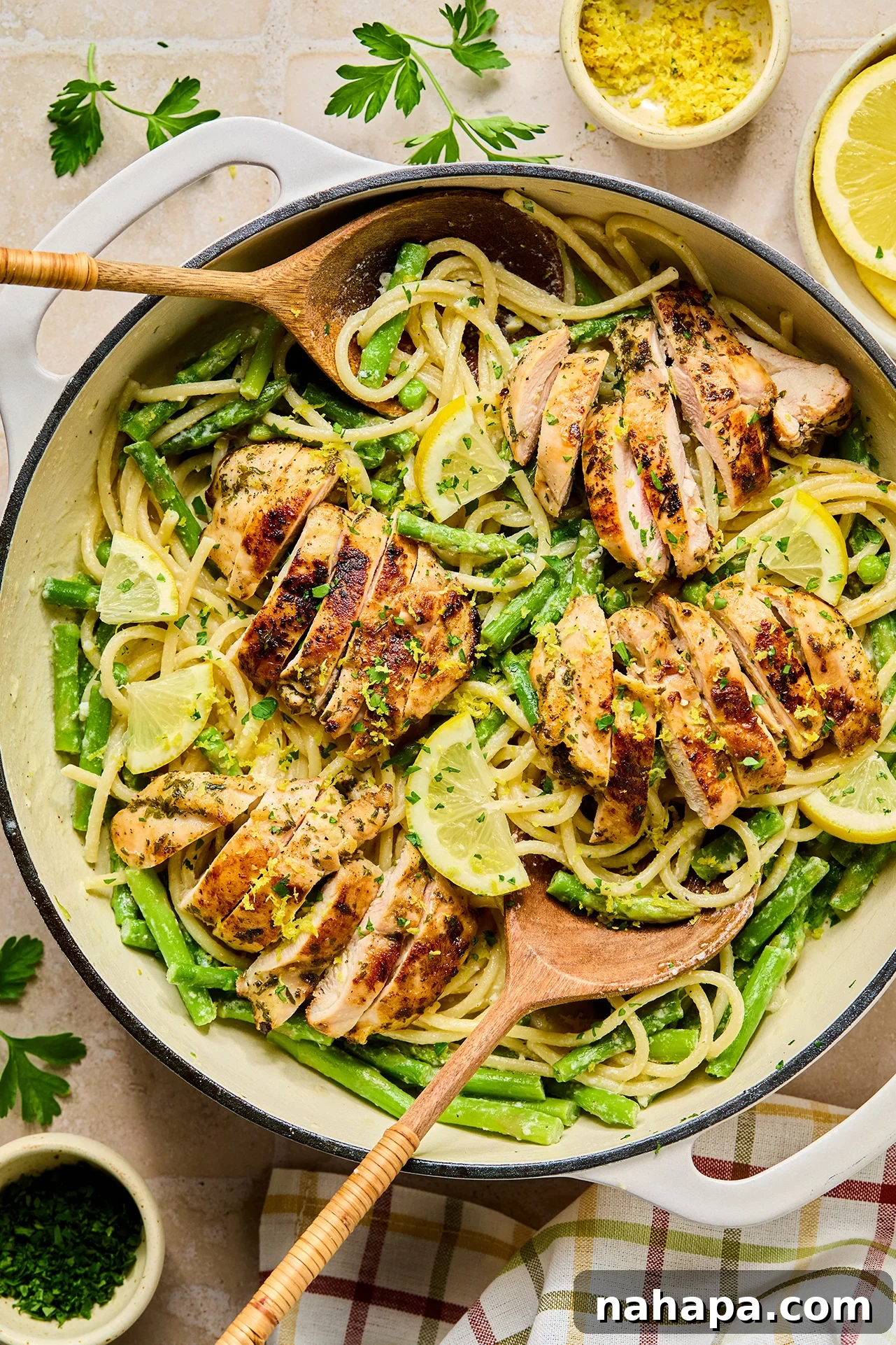 Bright Lemon Goat Cheese Pasta 11 A large pot of lemon goat cheese pasta after cooking, with a wooden serving spoon dipped into the creamy dish.