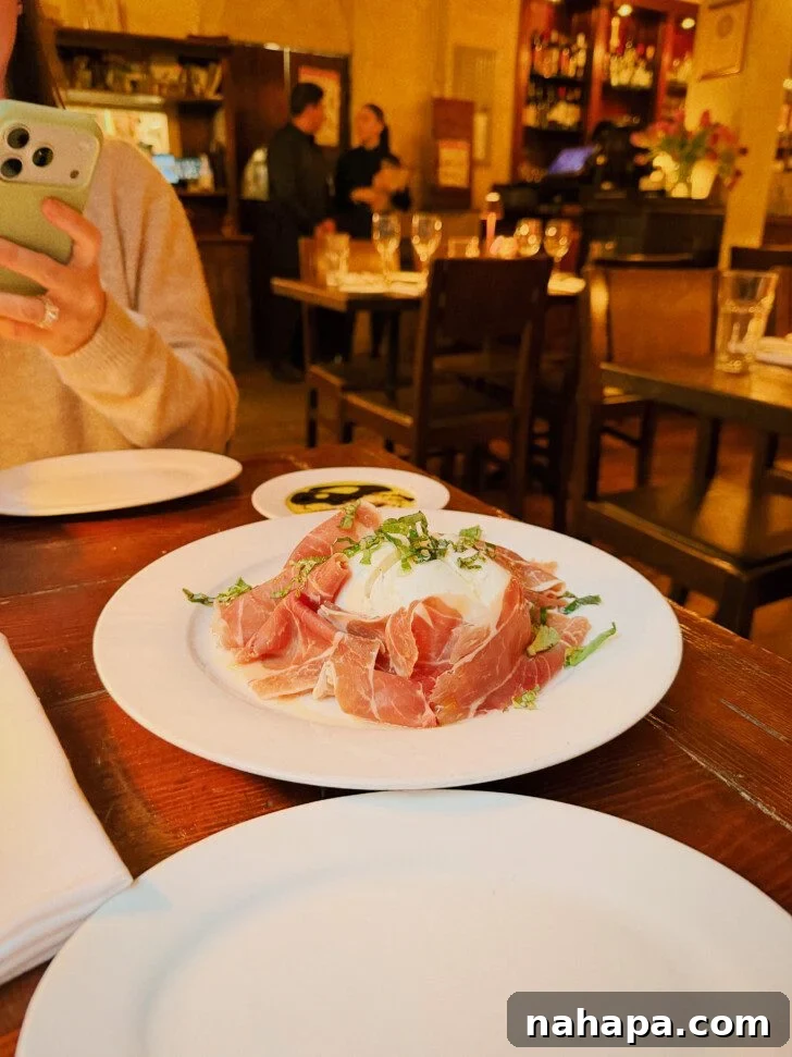 My Gluten-Free and Nightshade-Free NYC Food Guide 8 A beautifully arranged plate of fresh buffalo mozzarella and prosciutto in a restaurant setting, promising a delightful Italian appetizer.