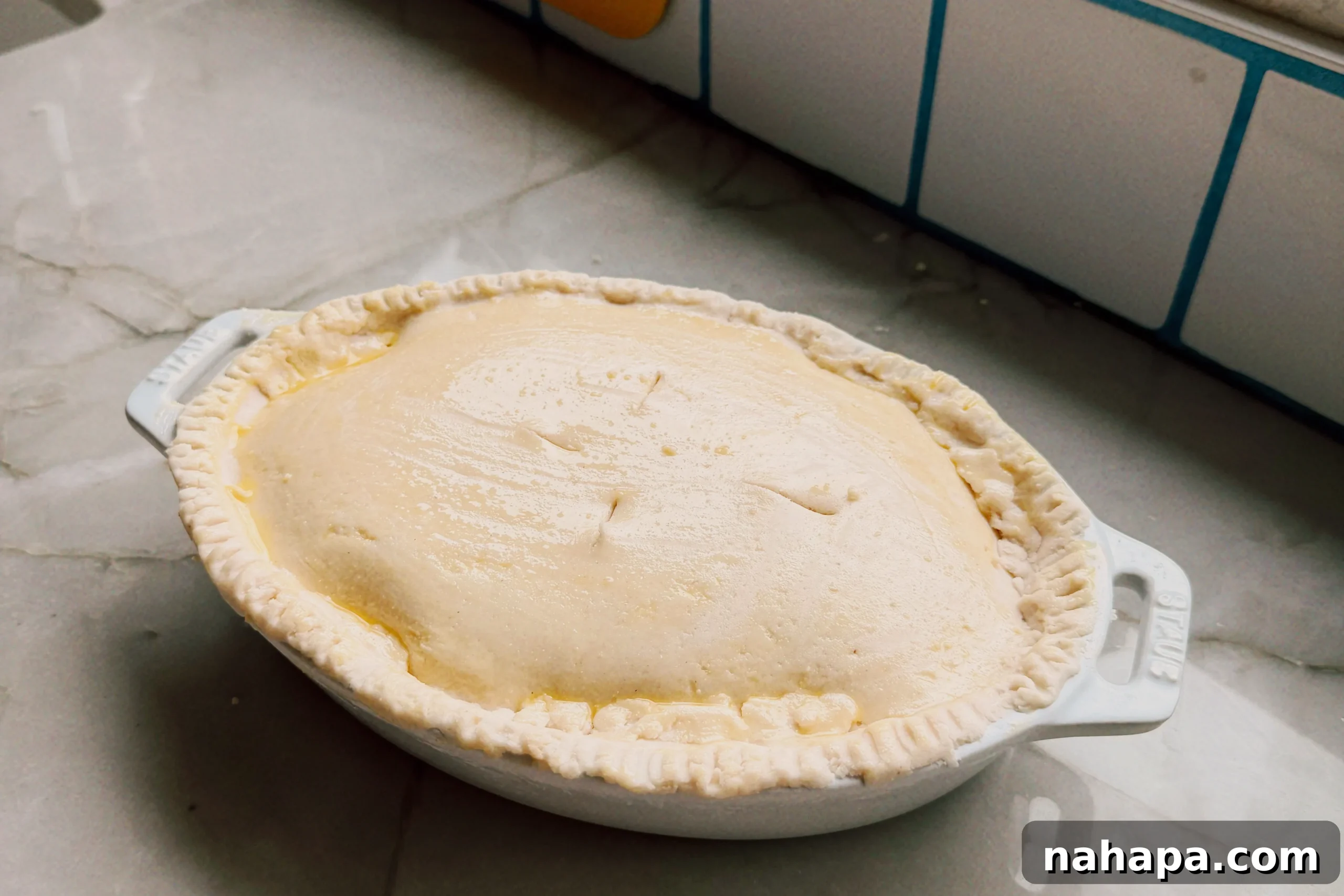 The beef pot pie after baking in the oven sitting on the counter before cutting into it.