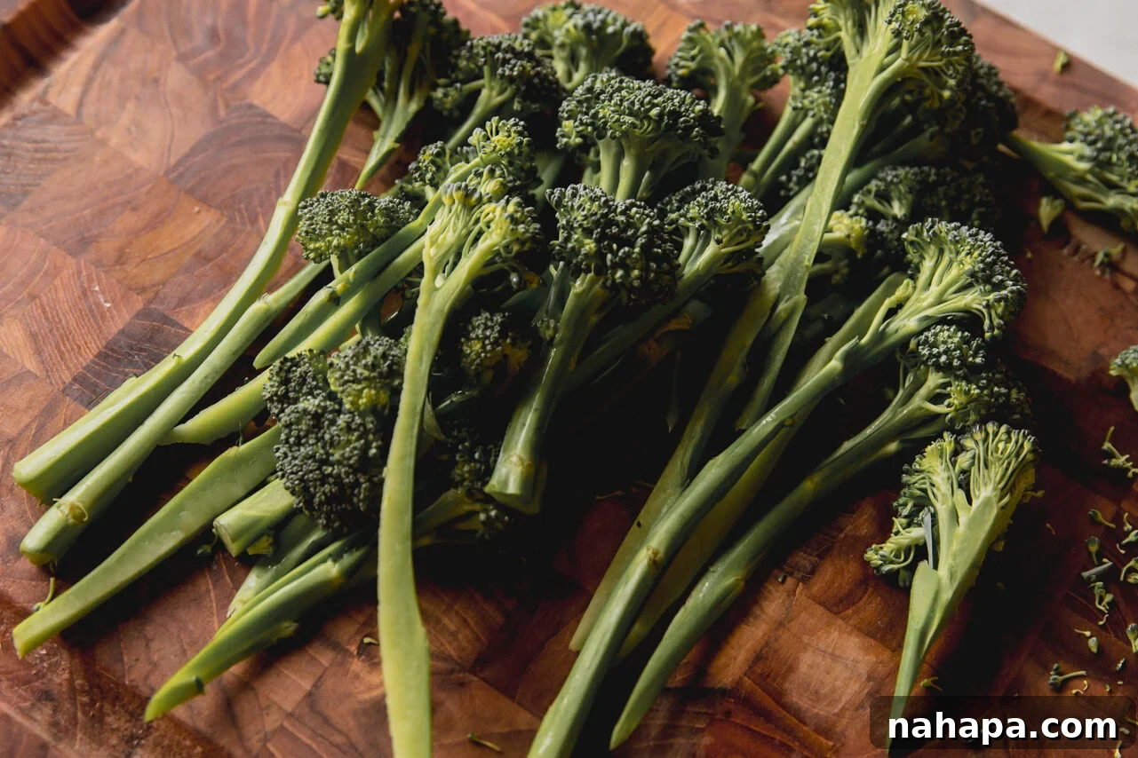 Sunshine-Spiced Chicken and Rice Broth 6 A wooden cutting board with freshly trimmed broccolini stalks.