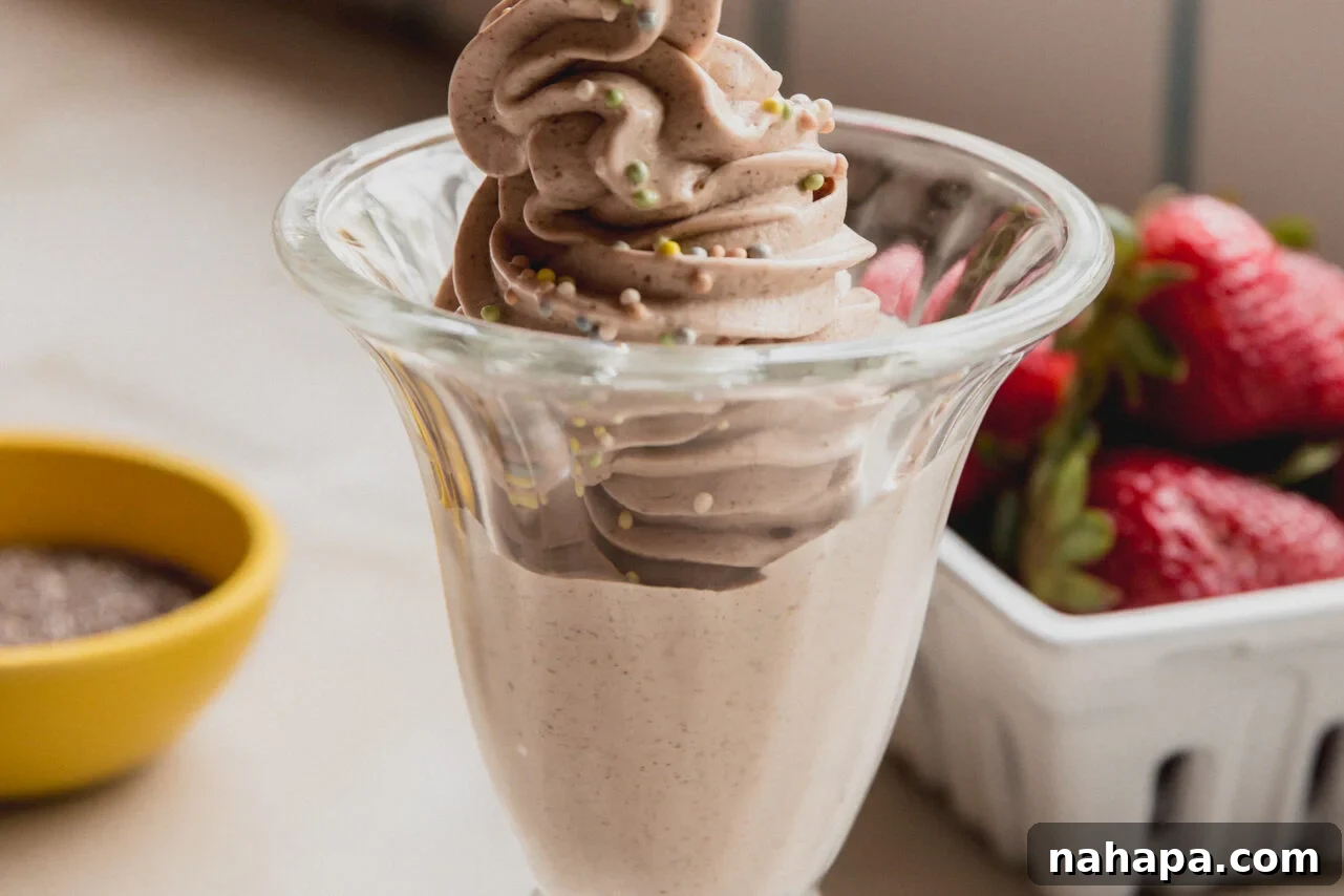 A serving of Chia Seed Ninja Creami Ice Cream in a clear glass bowl, beautifully topped with colorful sprinkles, ready to be enjoyed.