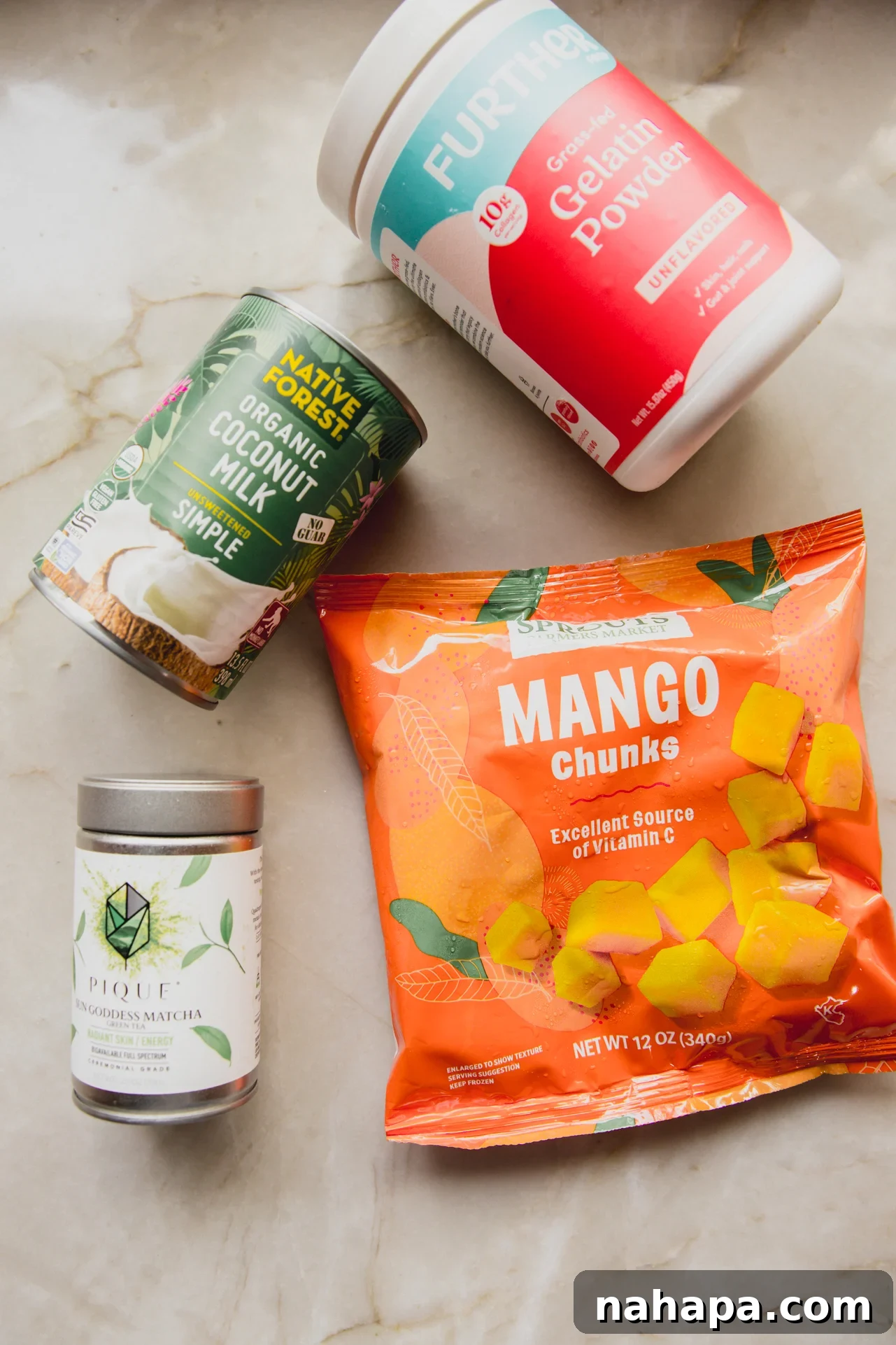 The main ingredients needed to make the matcha mango gummies laid out on the counter.