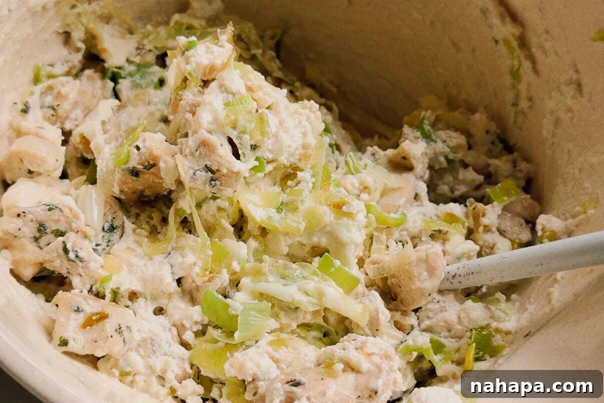 Luscious Dairy-Free Chicken Stuffed Shells 6 A white ceramic bowl with vegetables and chicken mixed with ricotta to make the shell stuffing mixture.