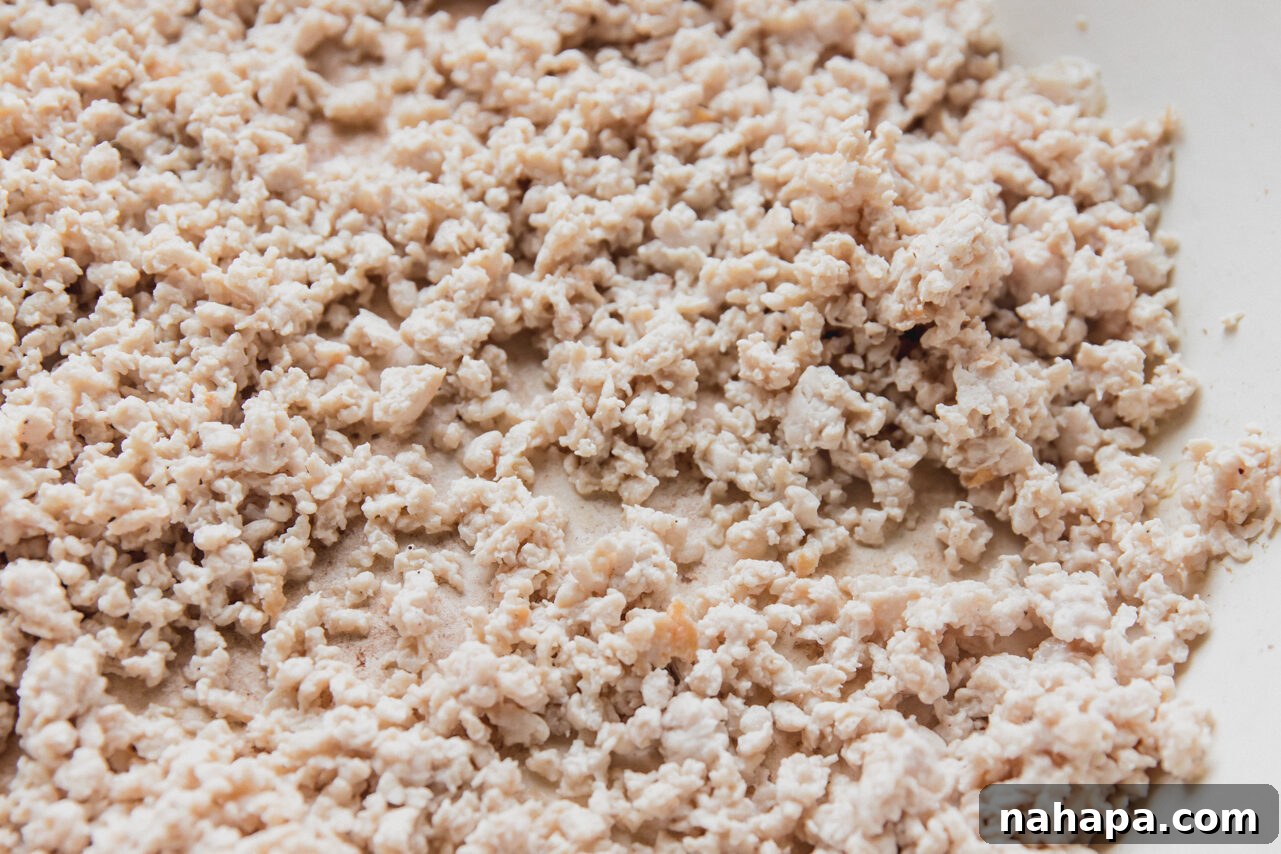 Ground chicken cooked and crumbled in a large pan until perfectly browned and fragrant with spices.
