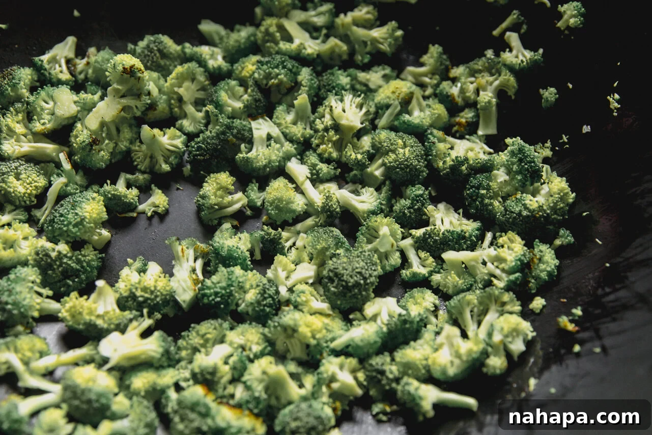 Beef and Broccoli Fried Rice Recipe with Garlic Soy Flavor 5 A wok with broccoli sauting in it.