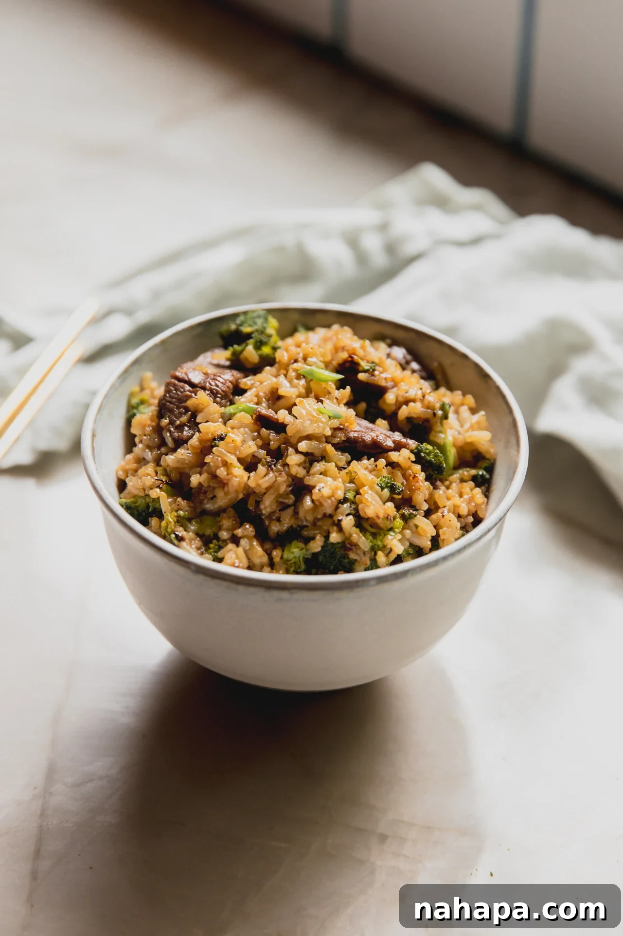 Beef and Broccoli Fried Rice Recipe with Garlic Soy Flavor 10 Beef and broccoli fried rice in a small white bowl.