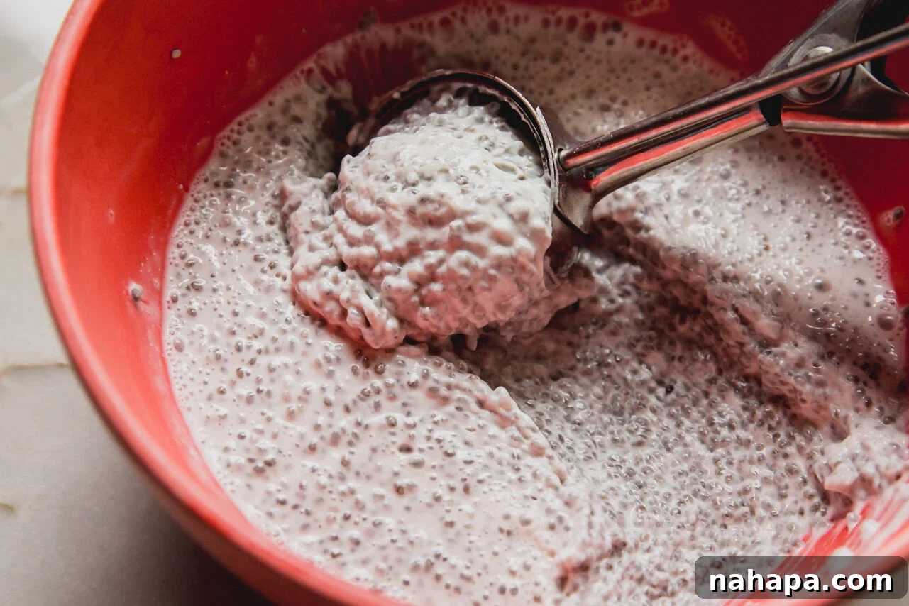 A red bowl filled with chia seed mixture after solidifying in the fridge. 