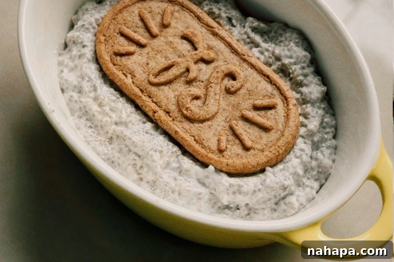 A ramekin filled with chia seed mixture with a breakfast biscuit on top. 