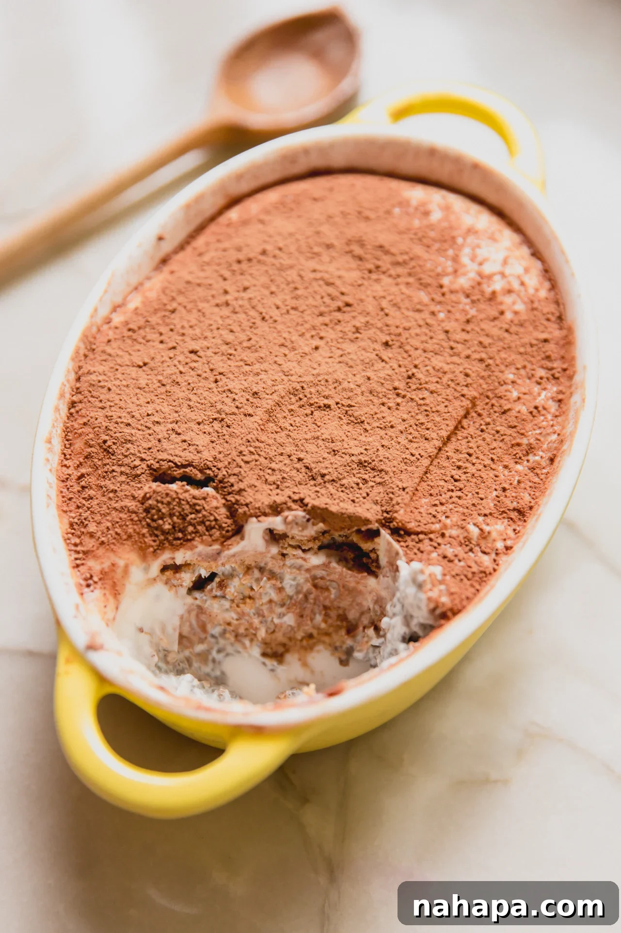 Protein tiramisu in a small yellow dish.