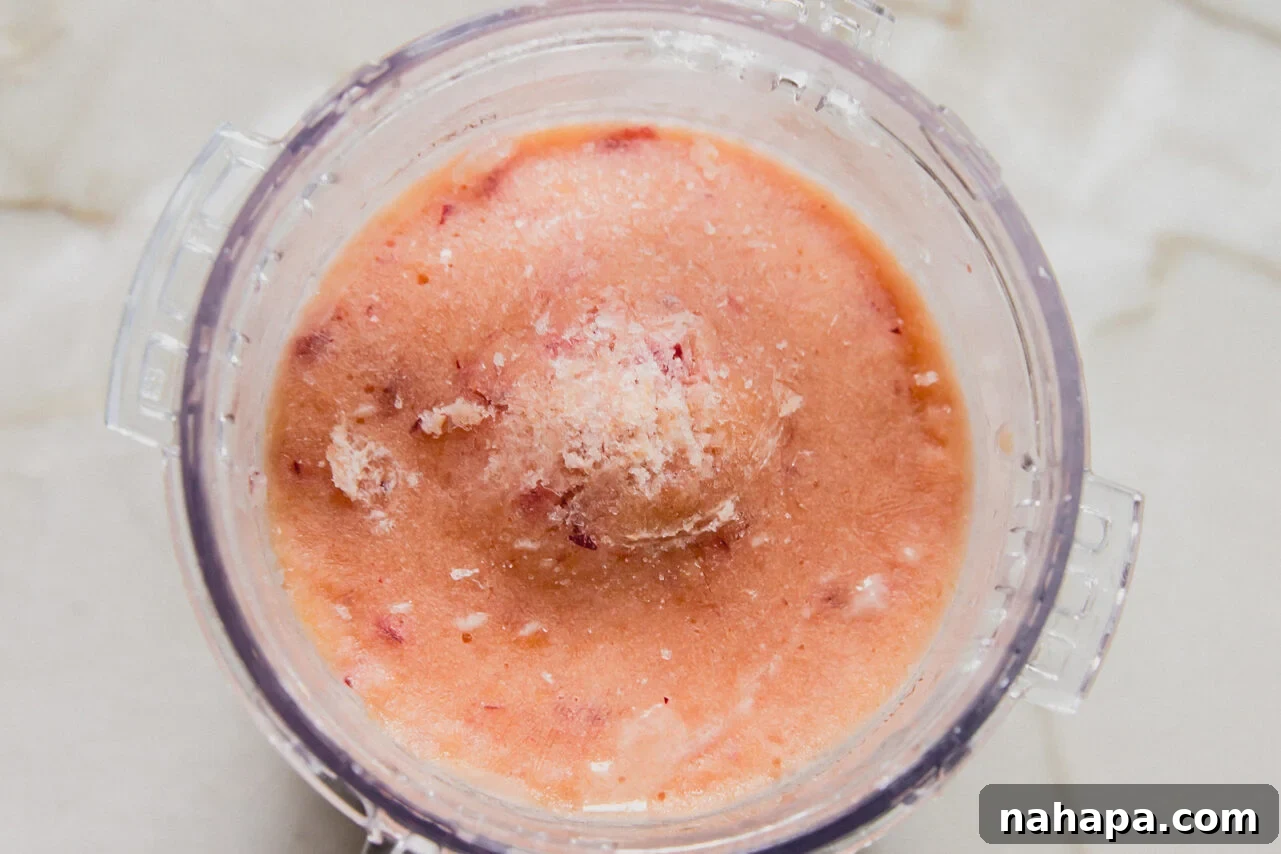 Peach ice cream in ninja creami, frozen before spinning.