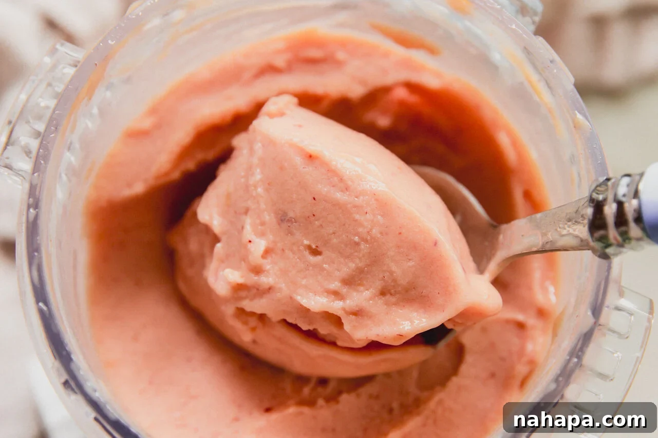 Ninja creami peach sorbet with a spoon.