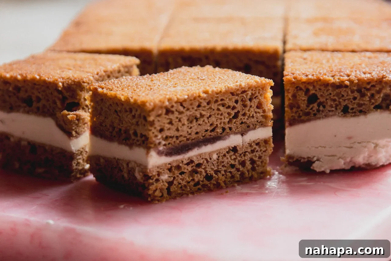Ice cream cake sandwich bars sliced on a cutting board.