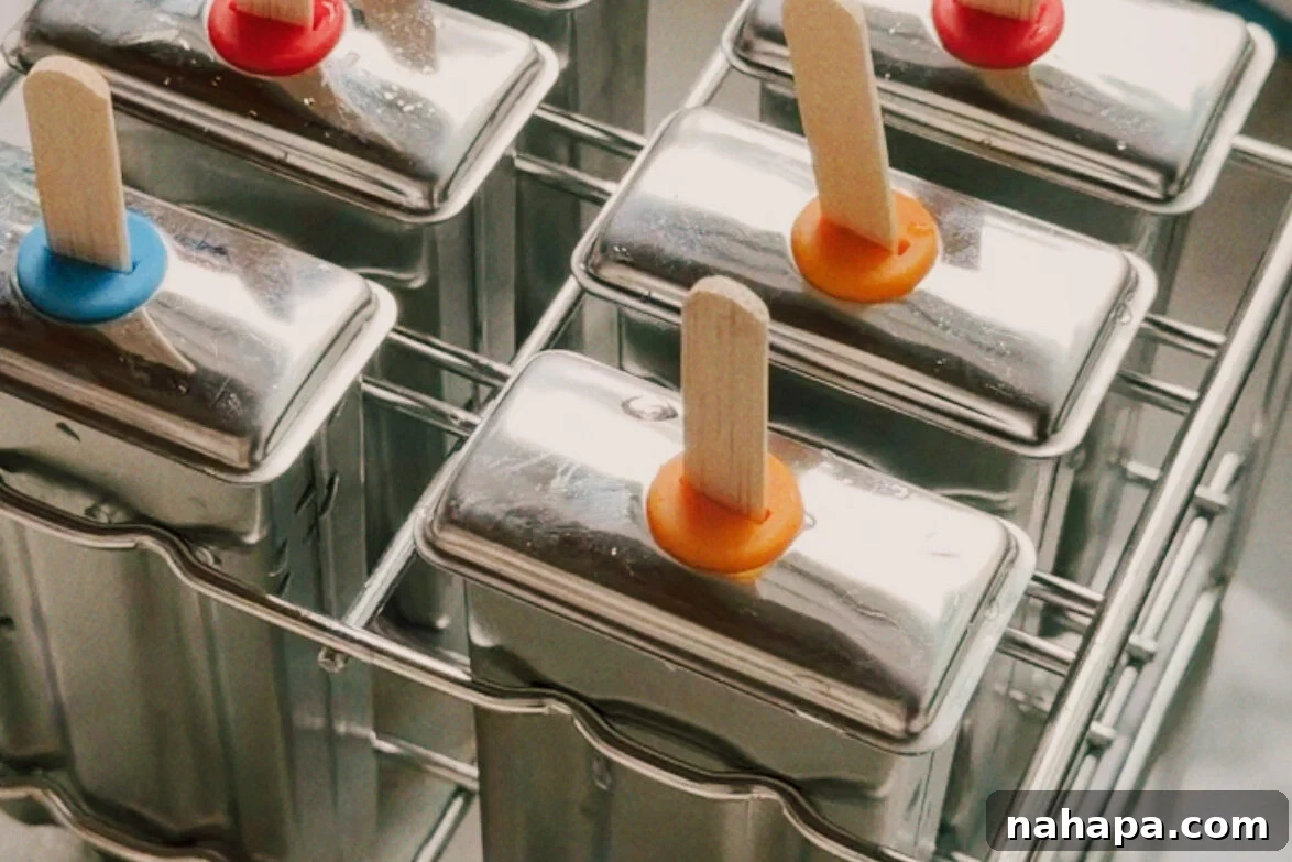 The popsicle molds filled and topped before freezing.