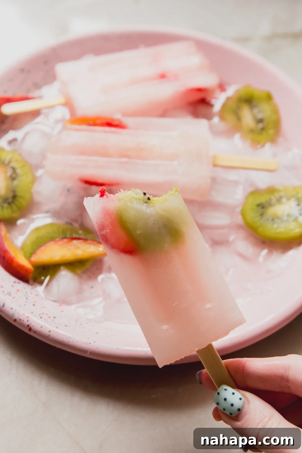 A popsicle after being frozen with a bite taken out of it.