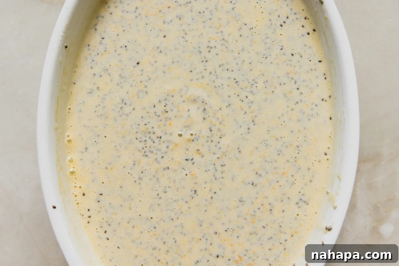 Mango chia pudding ingredients in a baking dish before setting