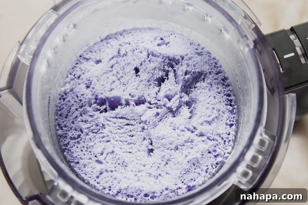 Ninja Creami Protein Cookie Monster Ice Cream Recipe 4 The ninja creami cup filled with the cookie monster ice cream after freezing.