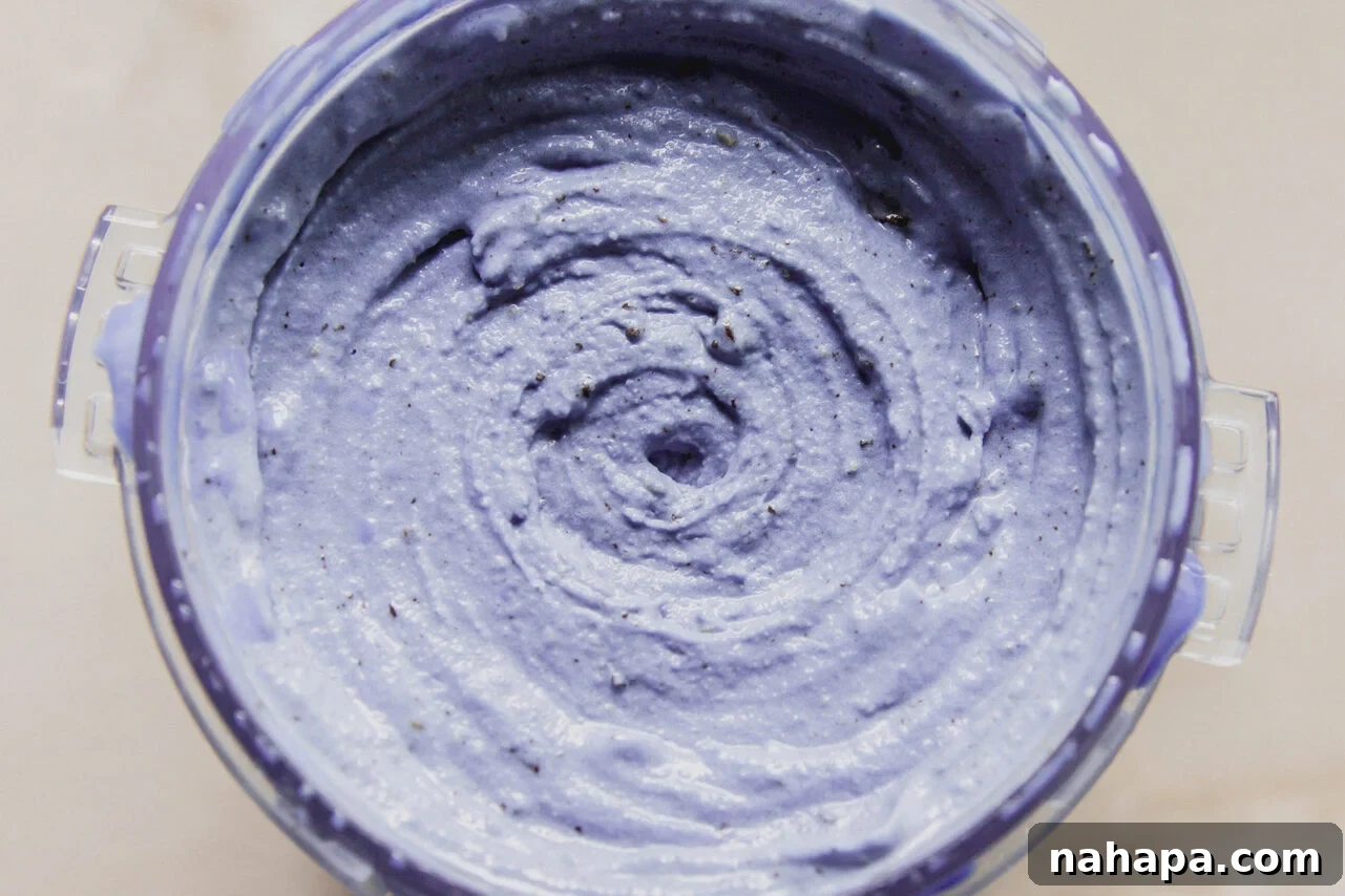 Ninja Creami Protein Cookie Monster Ice Cream Recipe 5 The ninja creami cup filled with the cookie monster ice cream after spinning.