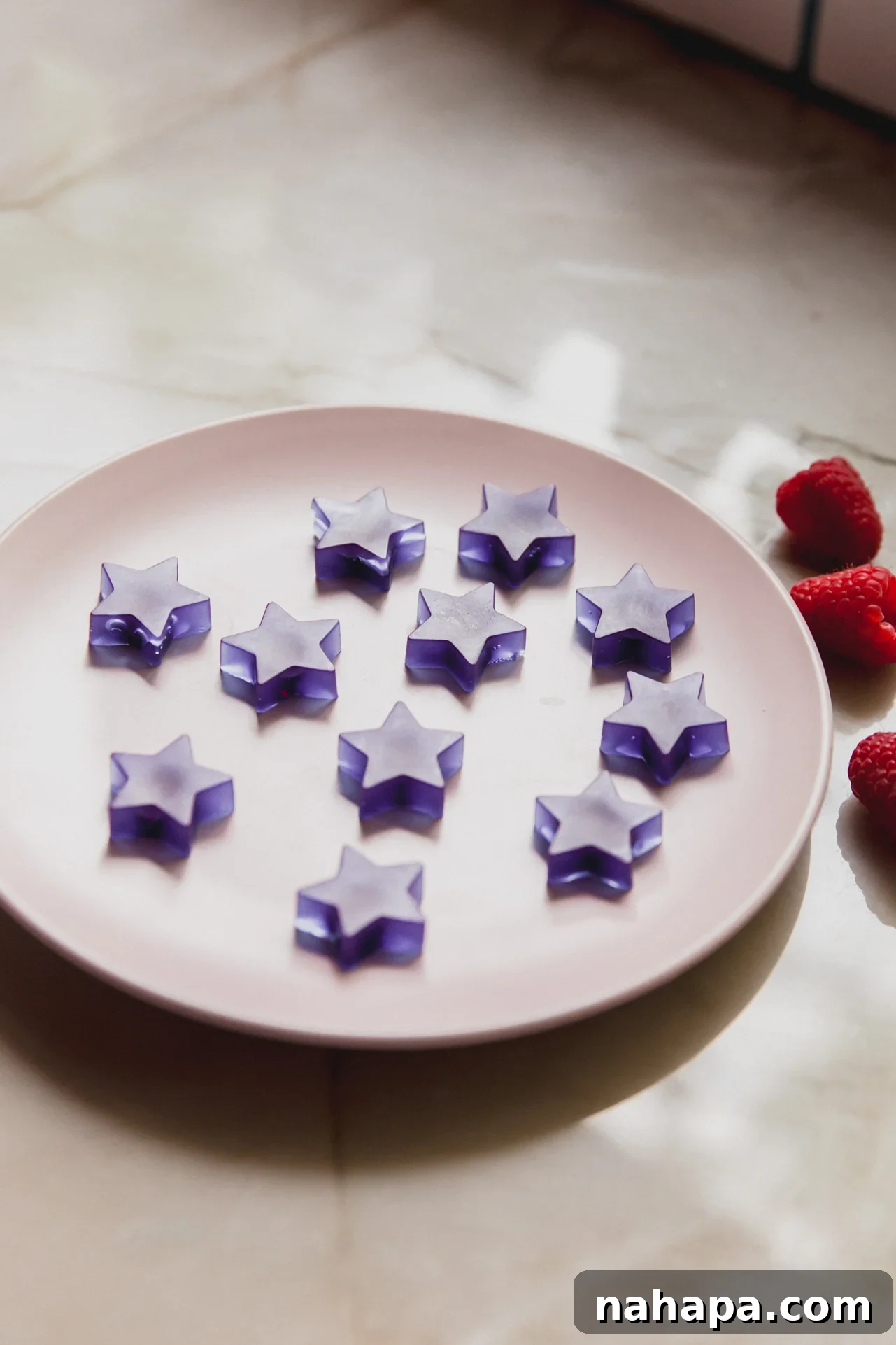 A white plate with blue raspberry gushers sitting on it.