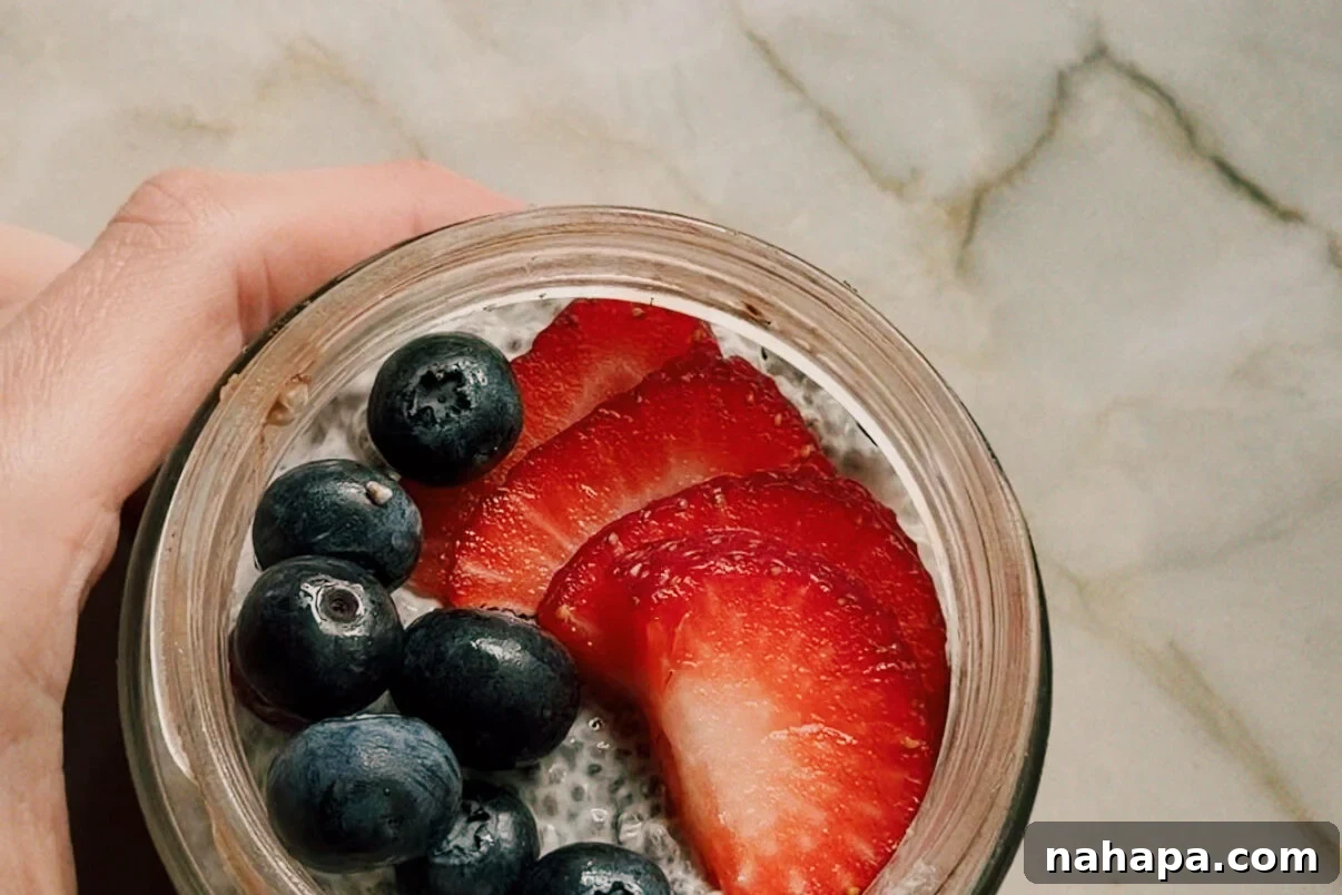 The final protein oatmeal breakfast cups topped with chia seed pudding and berries.