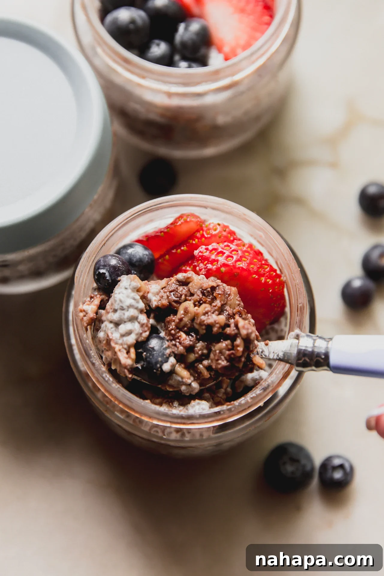 A spoon taking a bite out of the protein oatmeal breakfast cup.