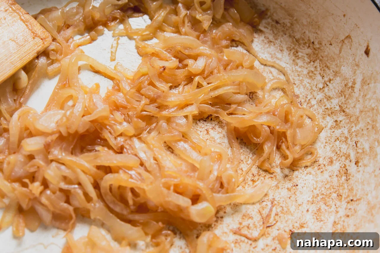 Caramelized Onion Breakfast Burritos with Eggs and Cheese 4 A pan with onions after caramelizing with a wooden spatula.