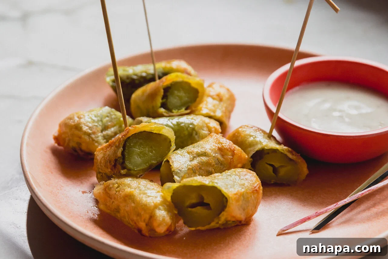 Rice paper fried pickles and ranch on a plate with toothpicks