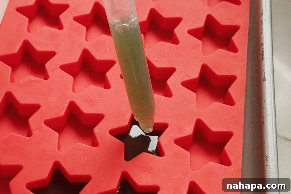A dropper transferring the gummy to the star mold.